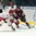 SPISSKA NOVA VES, SLOVAKIA - APRIL 23: Vladislav Yeryomenko #8 of Belarus and Latvia's Artjoms Lapiks #21 battle for the puck during relegation round action at the 2017 IIHF Ice Hockey U18 World Championship. (Photo by Steve Kingsman/HHOF-IIHF Images)

